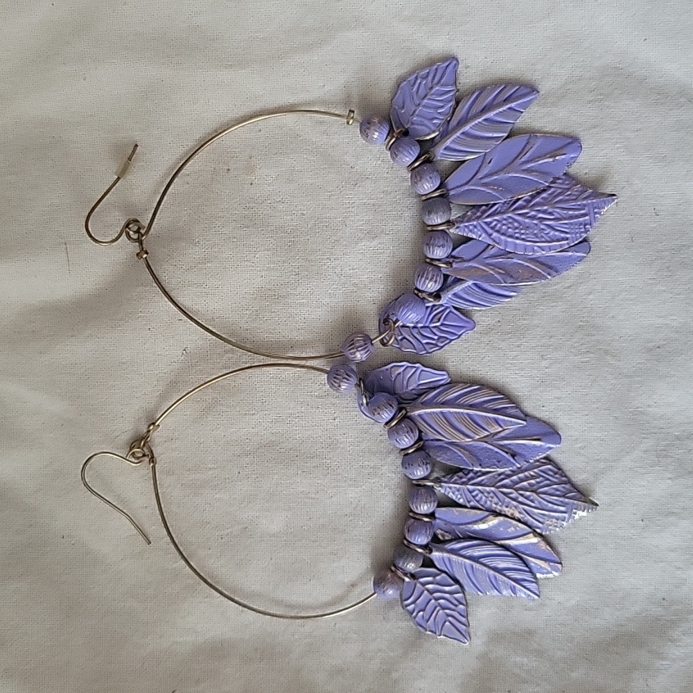 Gold thin hoops with feather detail.
